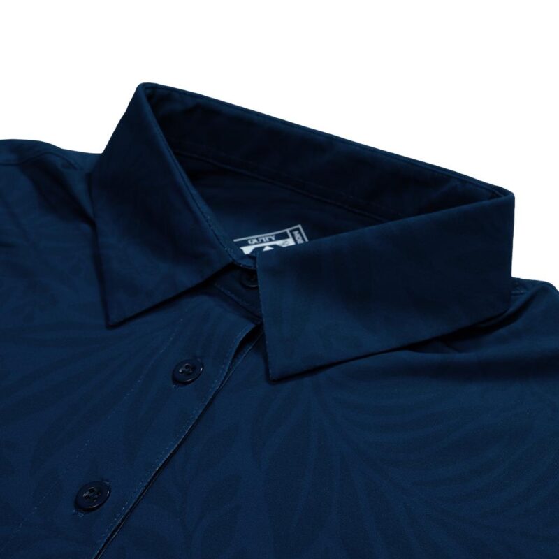 Close-up of a navy blue dress shirt collar with two dark buttons along the placket. Smooth fabric and sharp collar edges are visible, indicating a formal shirt.